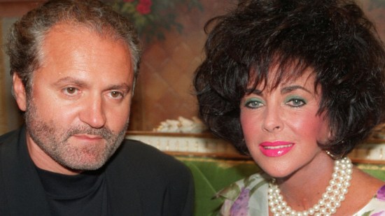 Italian fashion designer Gianni Versace is seen with actress Elizabeth Talyor while inaugurating his shop in Paris in this June 1991 photo. (AP Photo/Laurent Rebours)© RADIAL PRESS