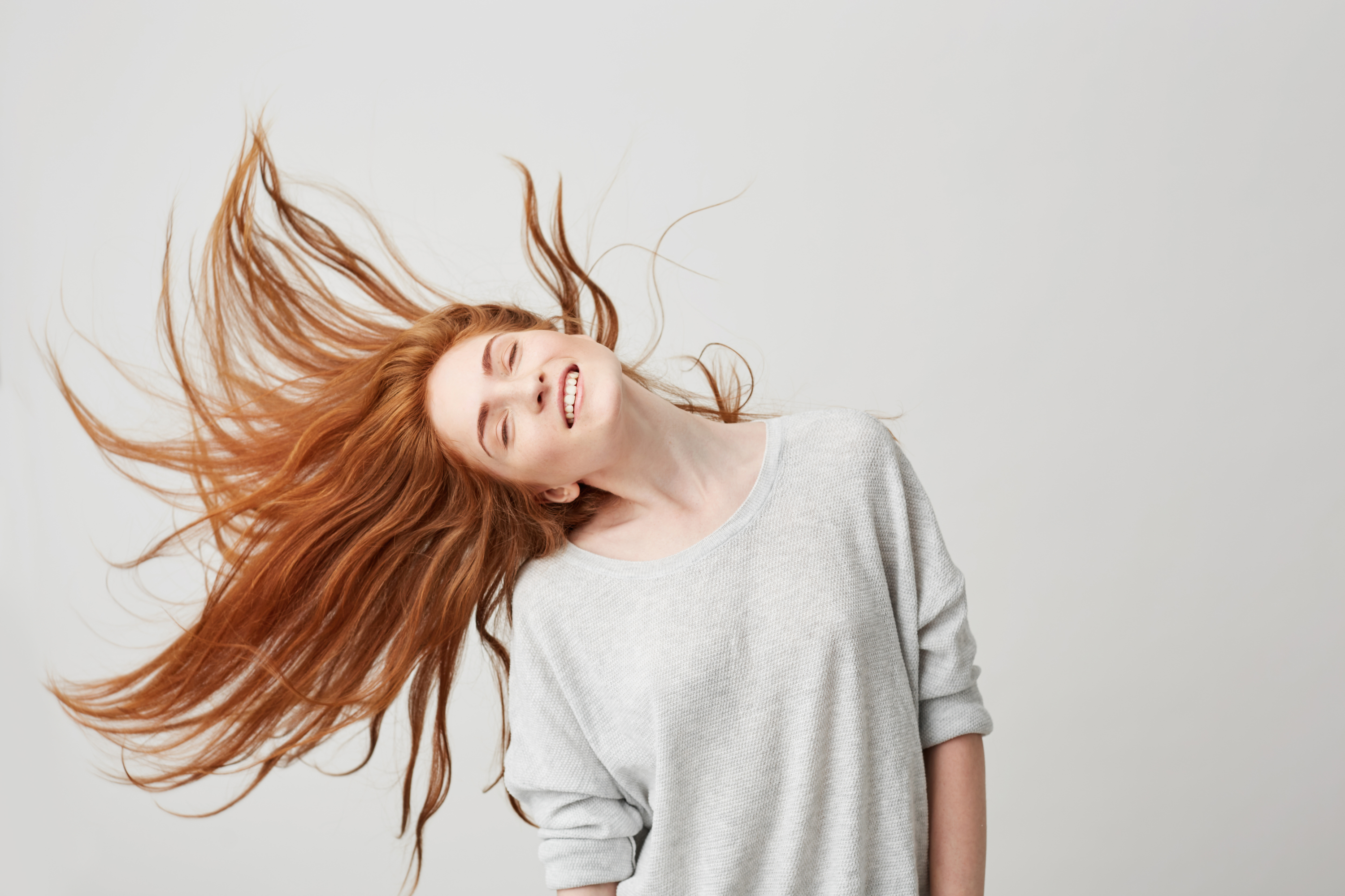 portrait-young-cheerful-beautiful-redhead-girl-smiling-with-closed-eyes-shaking-head-hair