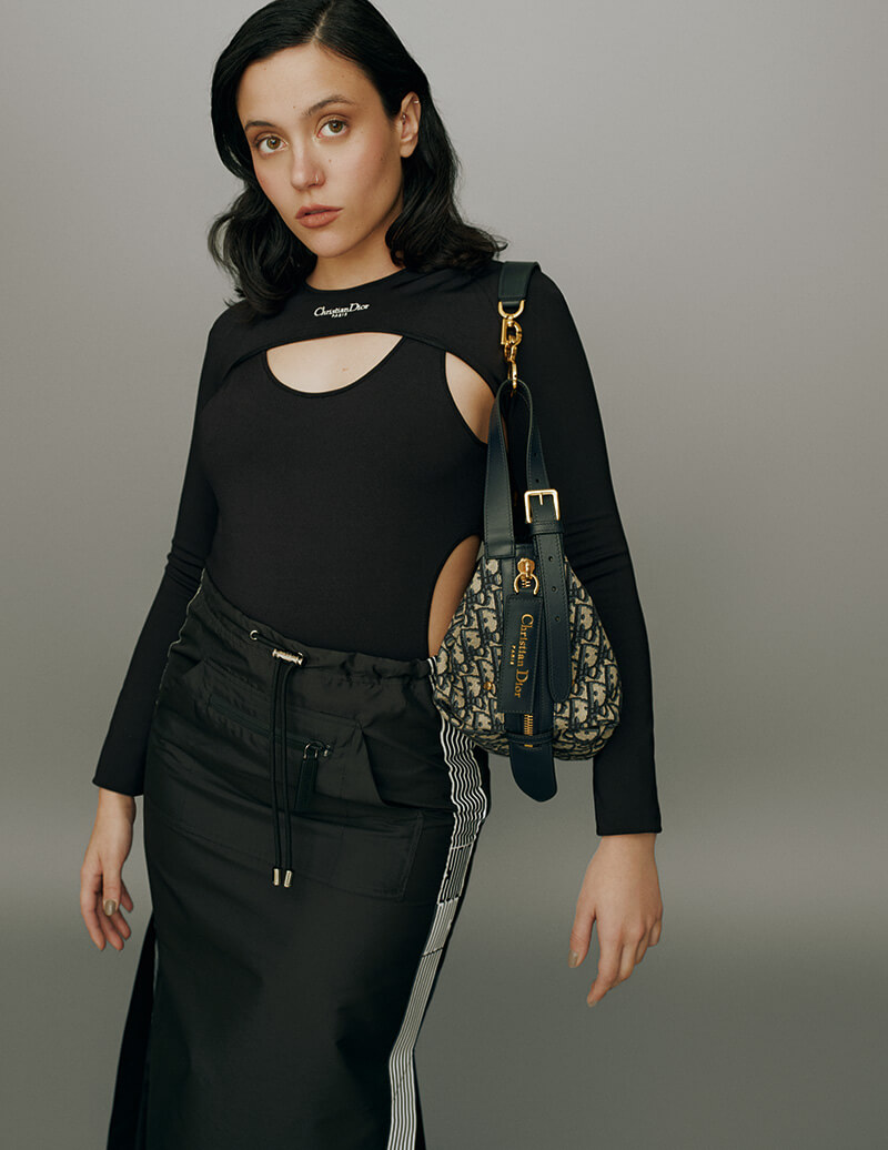 Body y mangas realizados en tejido técnico, falda de tafetán técnico Dior Graphique y bolso D-Journey pequeño. Todo, de Dior.
