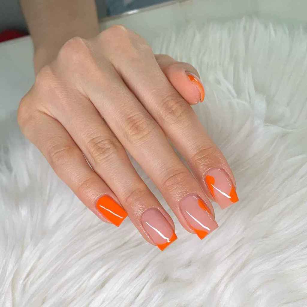 Manicura con detalles naranjas en uñas largas